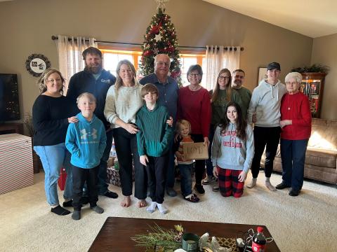Lisa and family in front of a Christmas tree