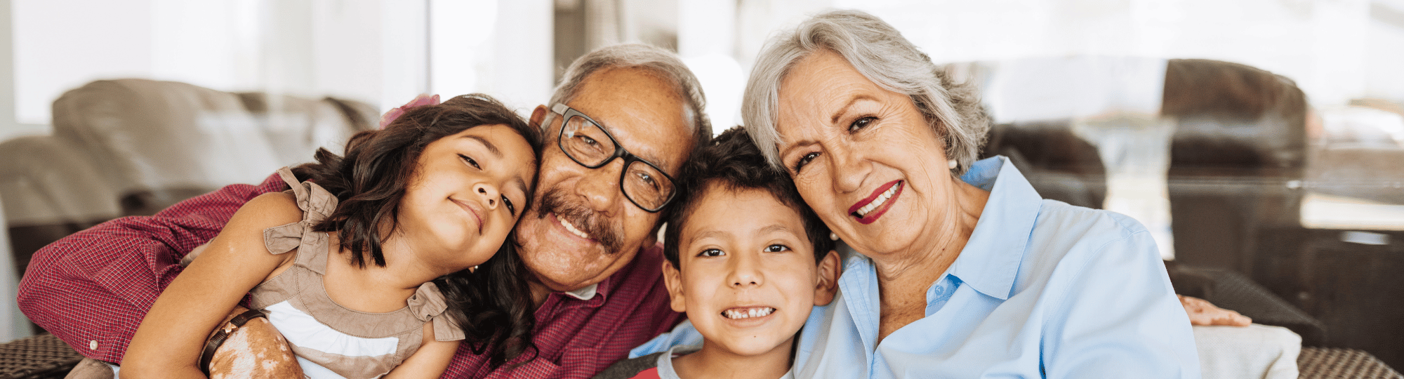 Close up group photo with two grandparents and two grandchildren hugging. 