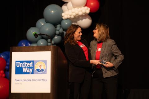 Kim Burma, 2025 Campaign Chair and Kate Kotzea, SEUW 2025 Board Chair embracing on Thank You Event stage