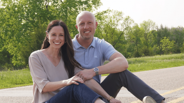 Jamie Hegge and her husband posing outdoors.