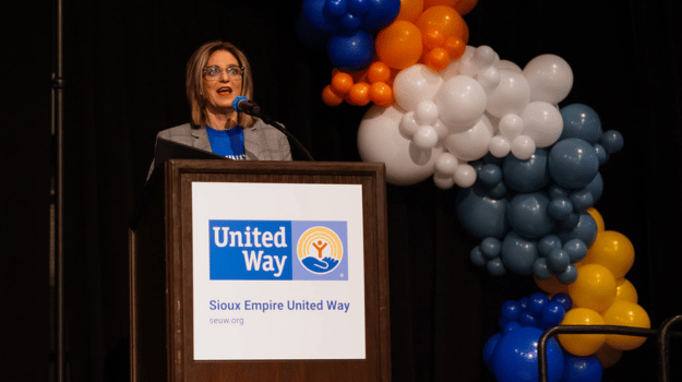 Kim Burma speaking on stage at the 2024 Sioux Empire United Way Thank You Event