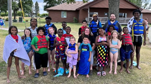 Kidstop teachers, volunteers, and children at Lake Pionsett Camp.